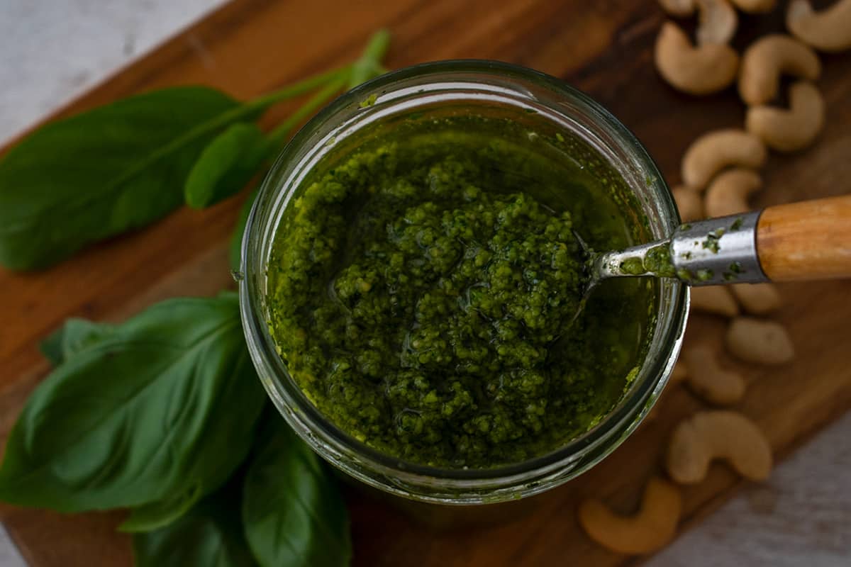 pesto de albahaca y espinacas con una cuchara de madera