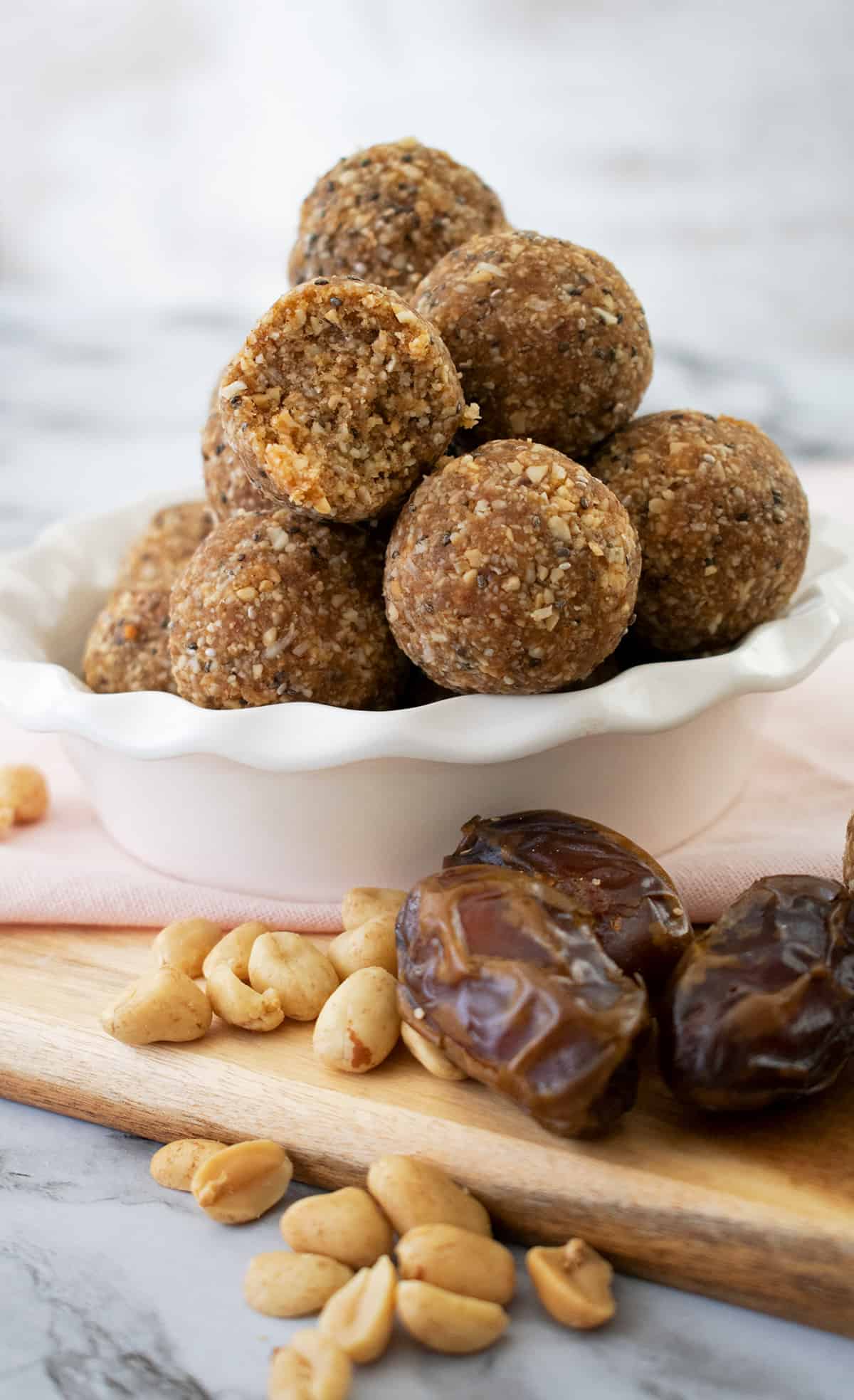 bolitas energéticas con dátiles y maní servidas en un bol blanco