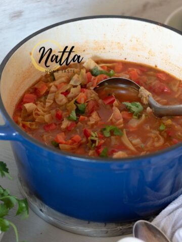 sopa de repollo y verduras servida en una olla azul